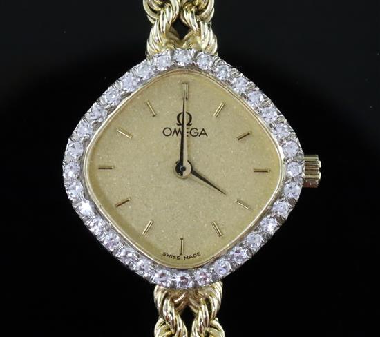 A ladys modern 14ct gold and diamond set Omega quartz dress wrist watch, overall length 18cm.